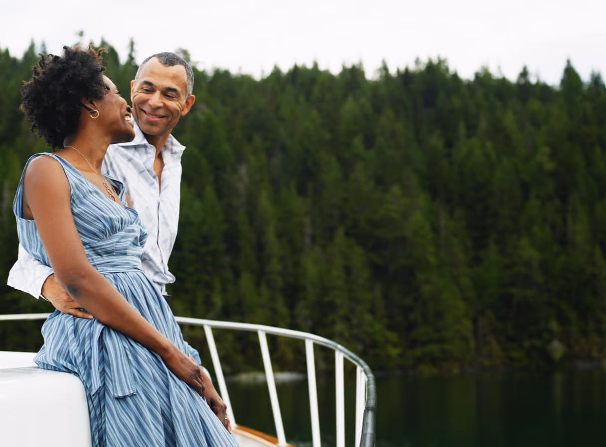Couple looking at each other outside on a boat.